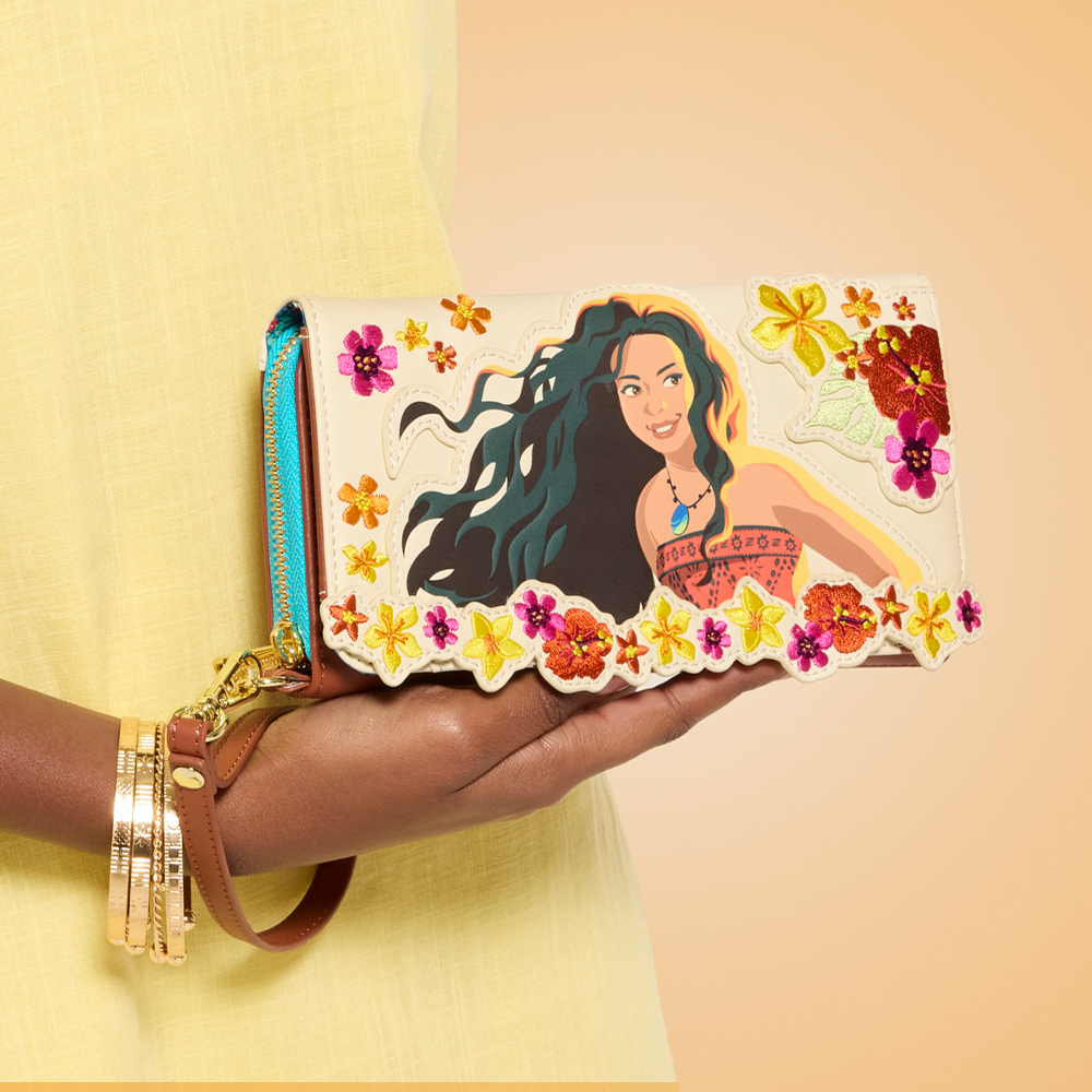 Orange background with model in Yellow dress showcasing Loungefly Disney Moana Live Action wallet