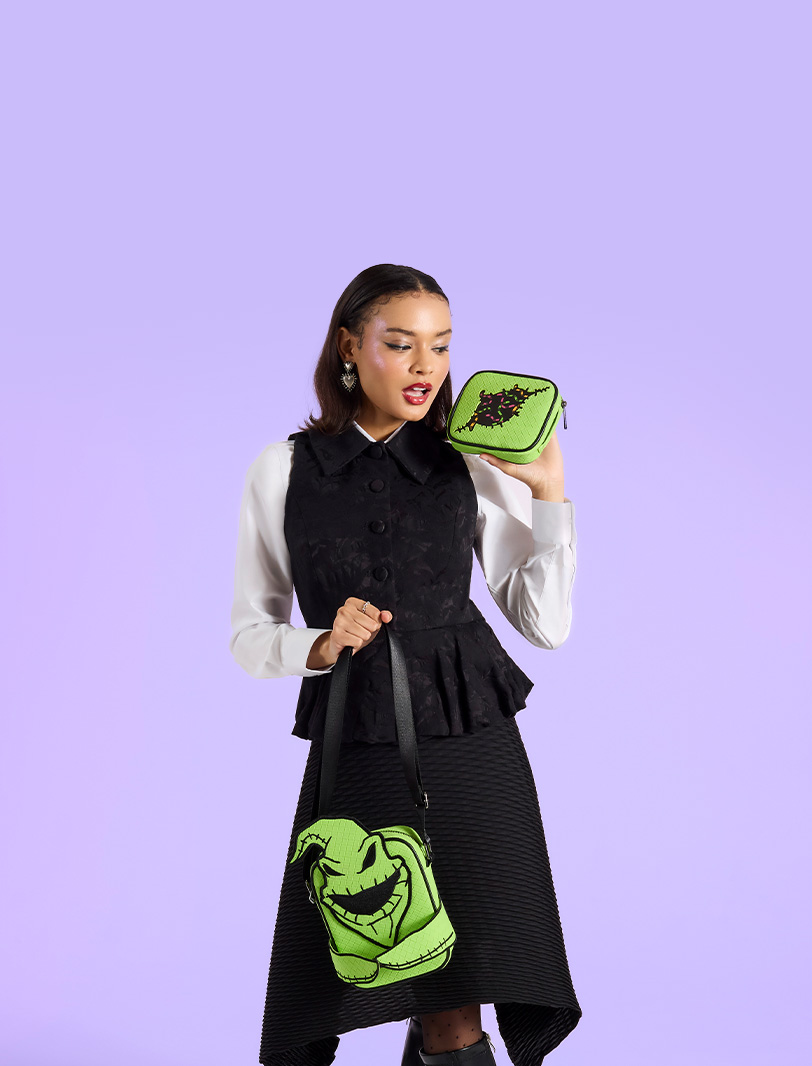Purple background with model showcasing Loungefly August Disney Nightmare Before Christmas Oogie Boogie Crossbuddies Bag